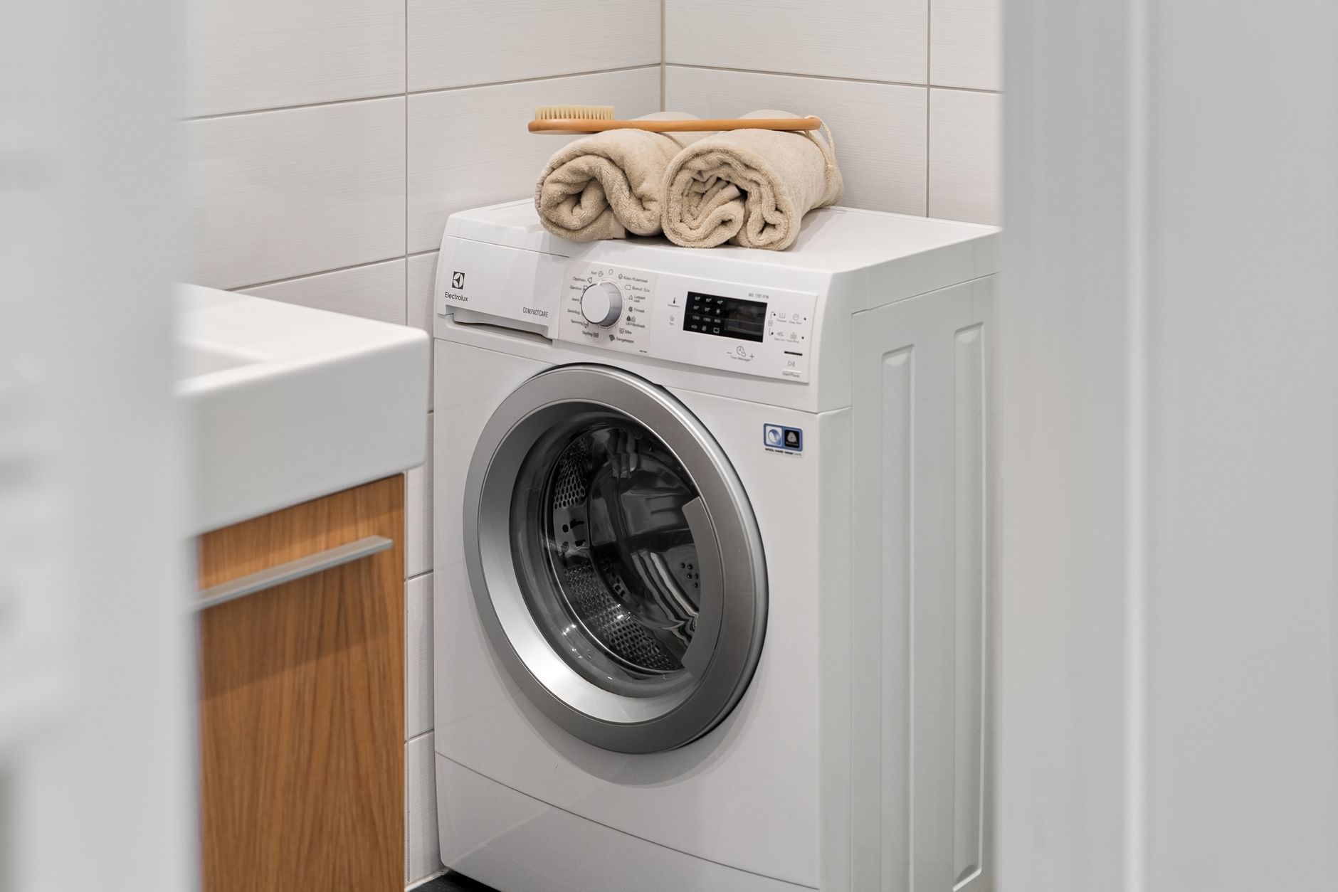white washing machine with beige towels