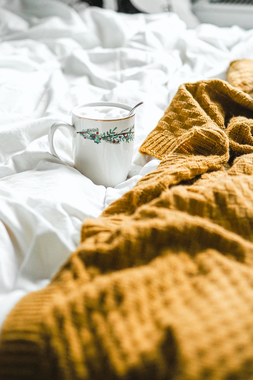 close up of a mug standing on a bed