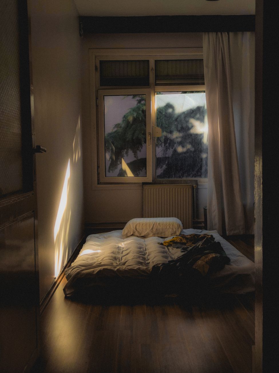 cozy sunlit room with mattress on floor