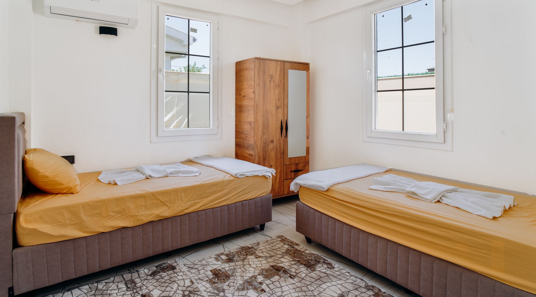 bright minimalist bedroom with twin beds