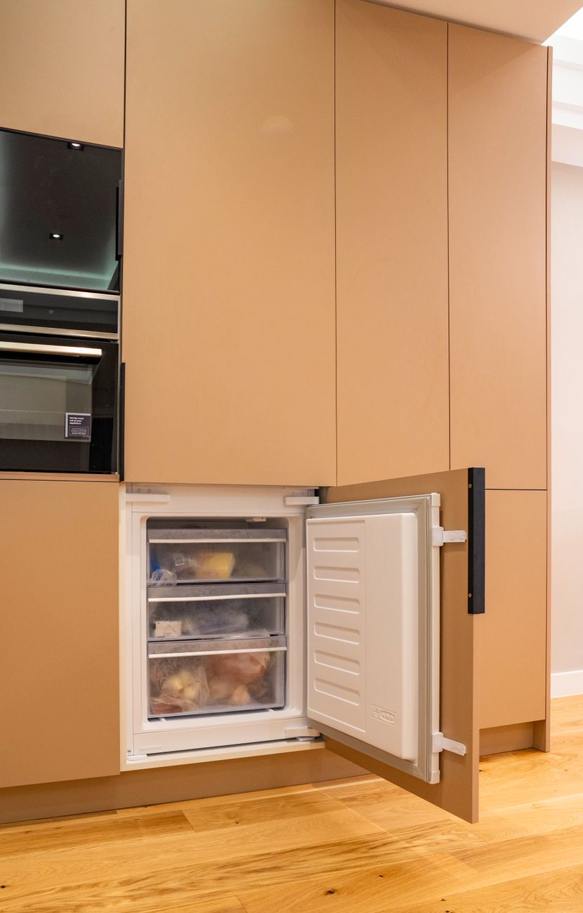 modern kitchen with open integrated freezer