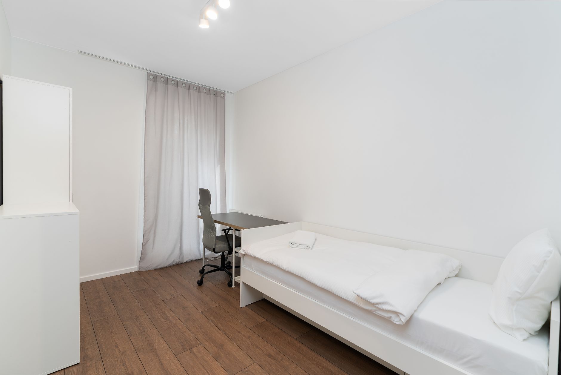 minimalist modern bedroom with white decor