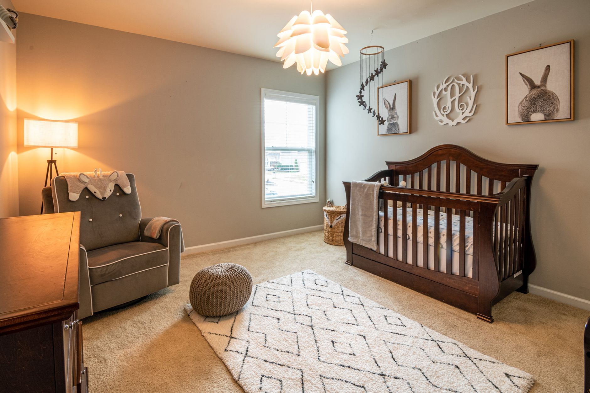 brown wooden baby crib near white wooden framed glass window
