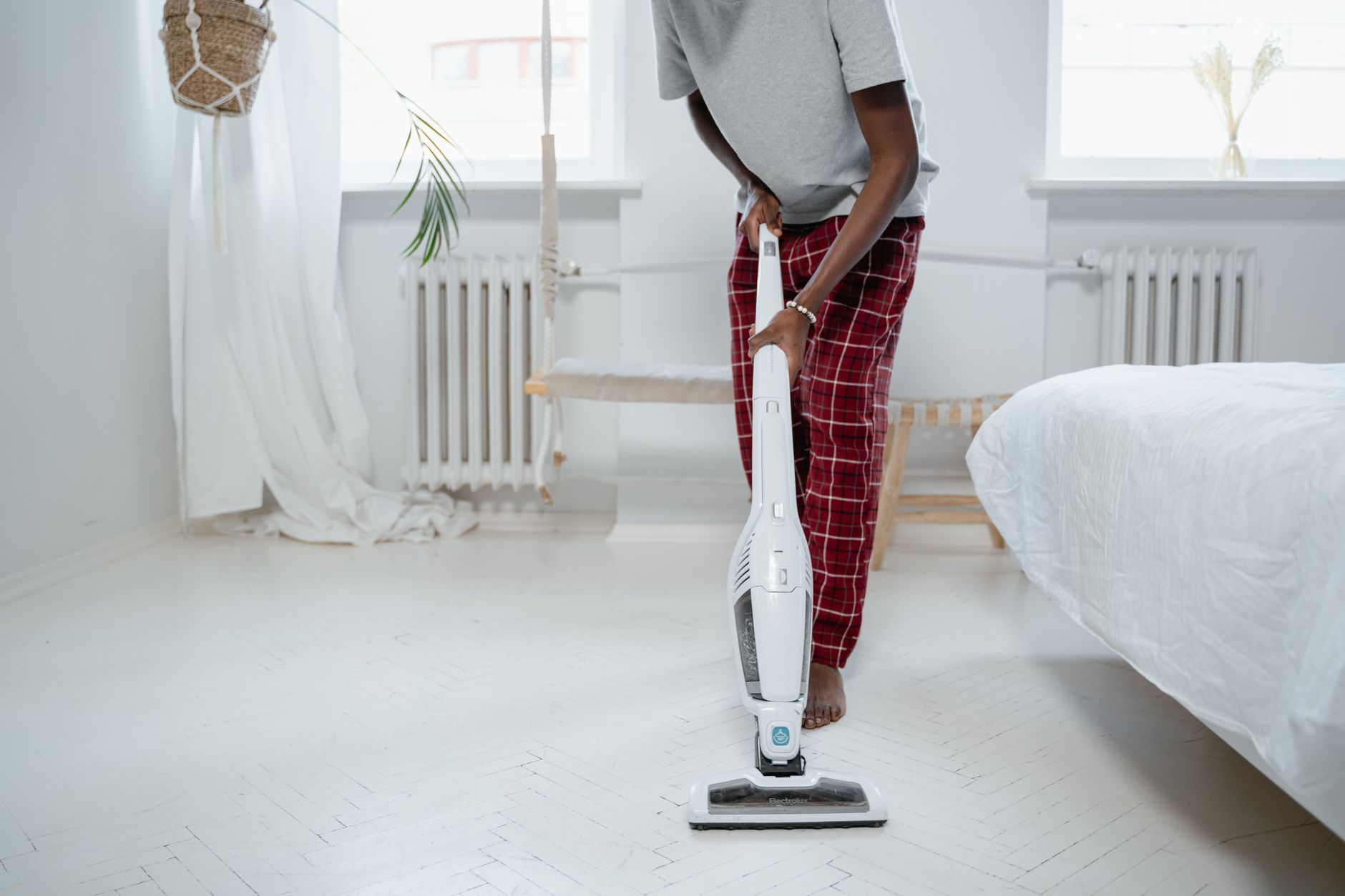 barefoot man using vacuum cleaner