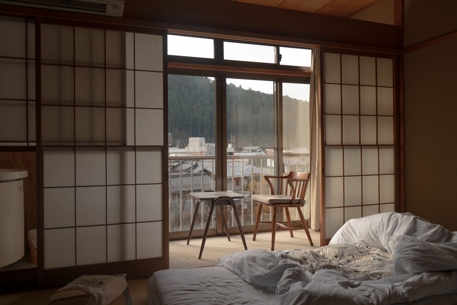empty wooden table and chair beside glass sliding door in the bedroom