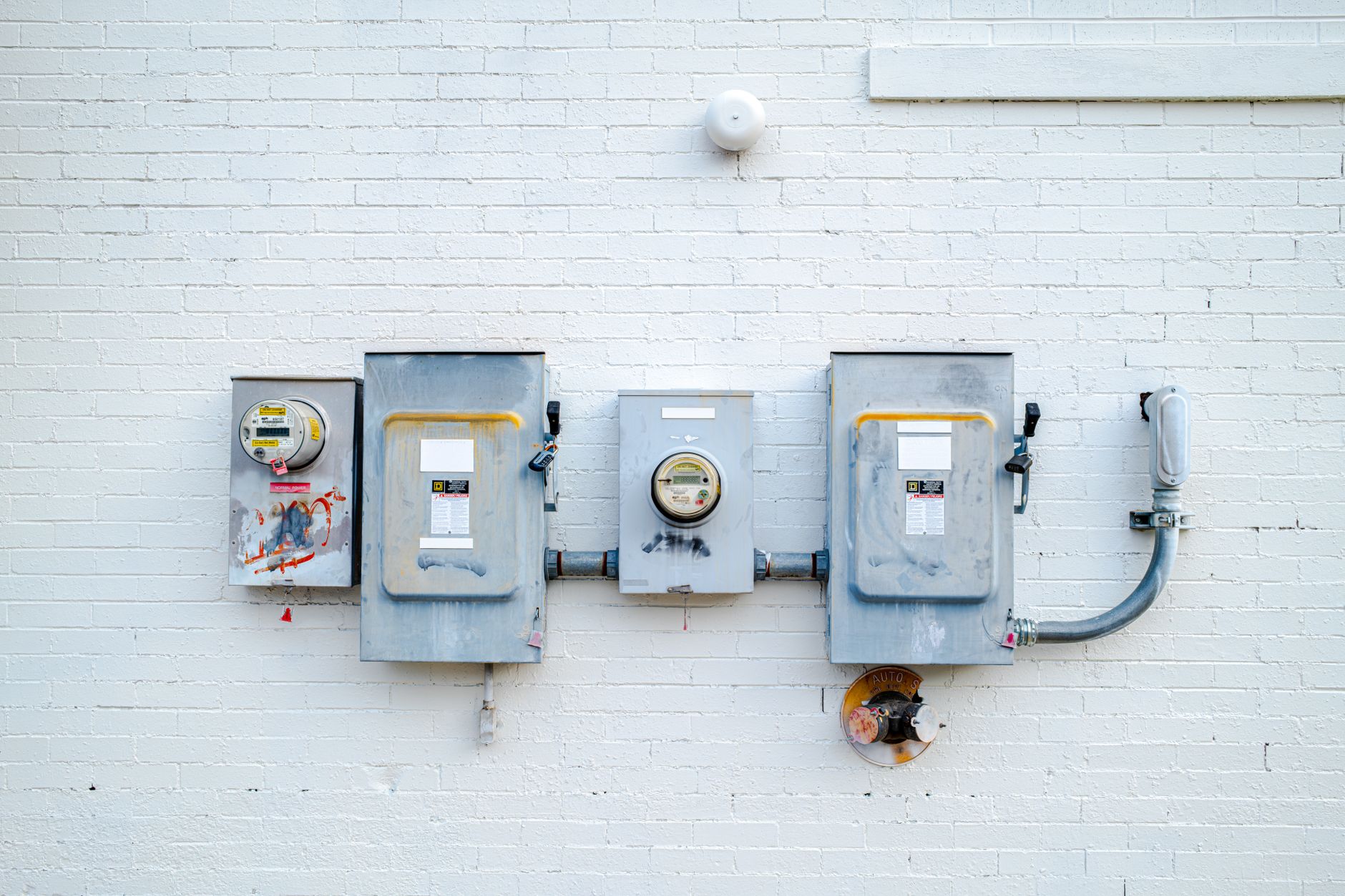 electrical boxes on white brick wall in chattanooga