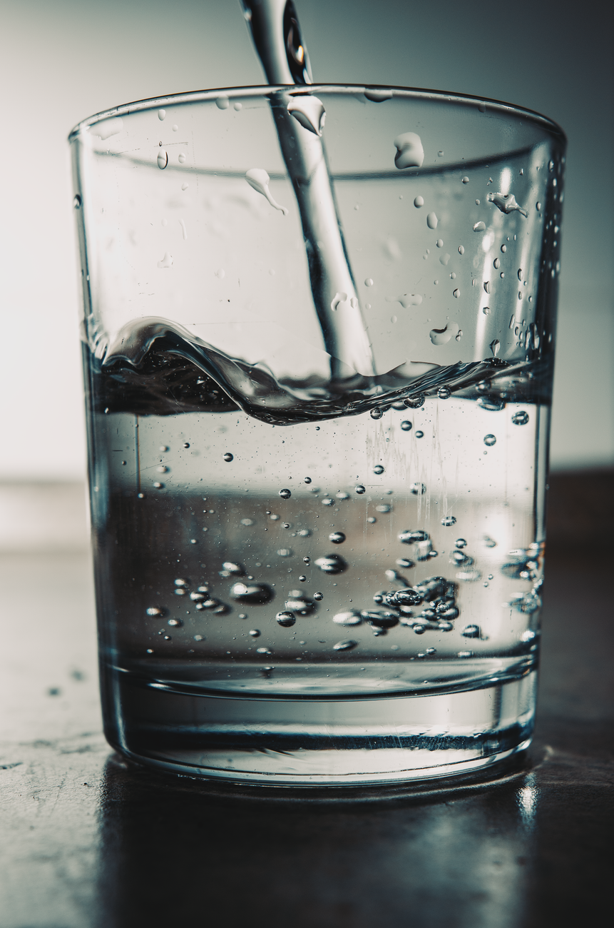close up of water pouring into glass